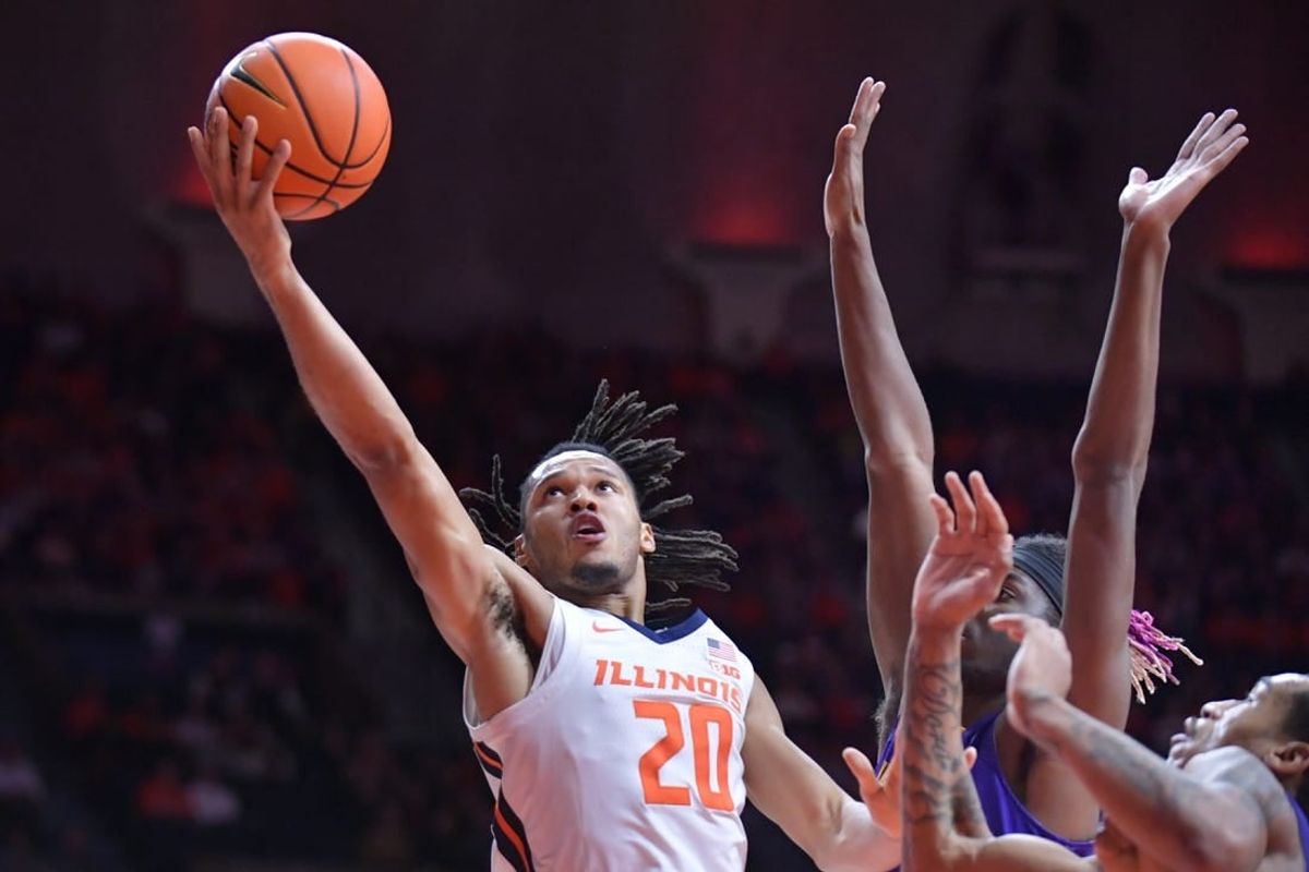Nov 24, 2023; Champaign, Illinois, USA;  Illinois Fighting Illini forward Ty Rodgers (20) drives to the basket during the first half against the Western Illinois Leathernecks at State Farm Center.