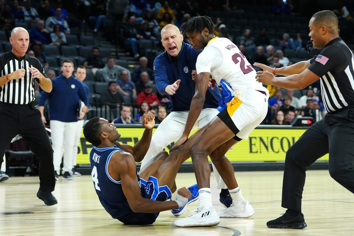 Nov 23, 2023; Las Vegas, Nevada, USA; Brigham Young Cougars head coach Mark Pope attempts to break up an altercation between Brigham Young Cougars forward Atiki Ally Atiki (4) and Arizona State Sun Devils forward Akil Watson (23) during the second half at Michelob Ultra Arena.