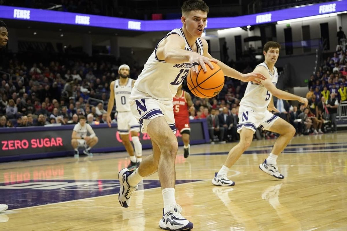 Jan 17, 2024; Evanston, Illinois, USA; Northwestern Wildcats guard Brooks Barnhizer (13) grabs a loose ball against the Maryland Terrapins during the first half at Welsh-Ryan Arena.