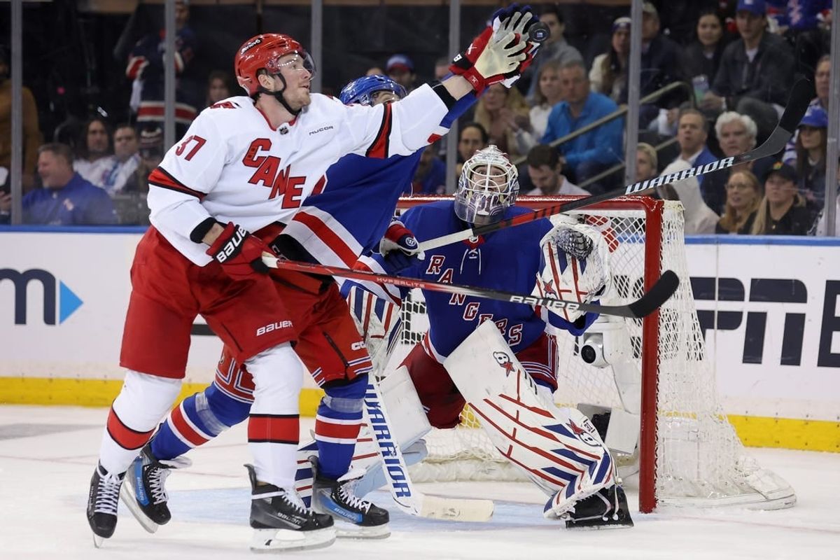 May 7, 2024; New York, New York, USA; Carolina Hurricanes right wing Andrei Svechnikov (37) fights for the puck against New York Rangers center Vincent Trocheck (16) and goaltender Igor Shesterkin (31) during the second period of game two of the second round of the 2024 Stanley Cup Playoffs at Madison Square Garden.