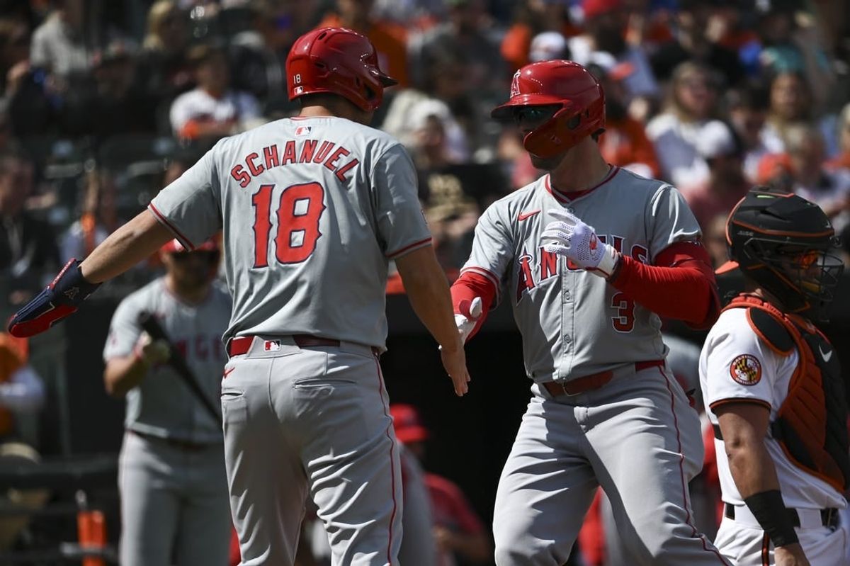 Mar 31, 2024; Baltimore, Maryland, USA;  Los Angeles Angels left fielder Taylor Ward (3) celebrates with  first baseman Nolan Schanuel (18) at home plate after hitting a first inning home run H| at Oriole Park at Camden Yards.