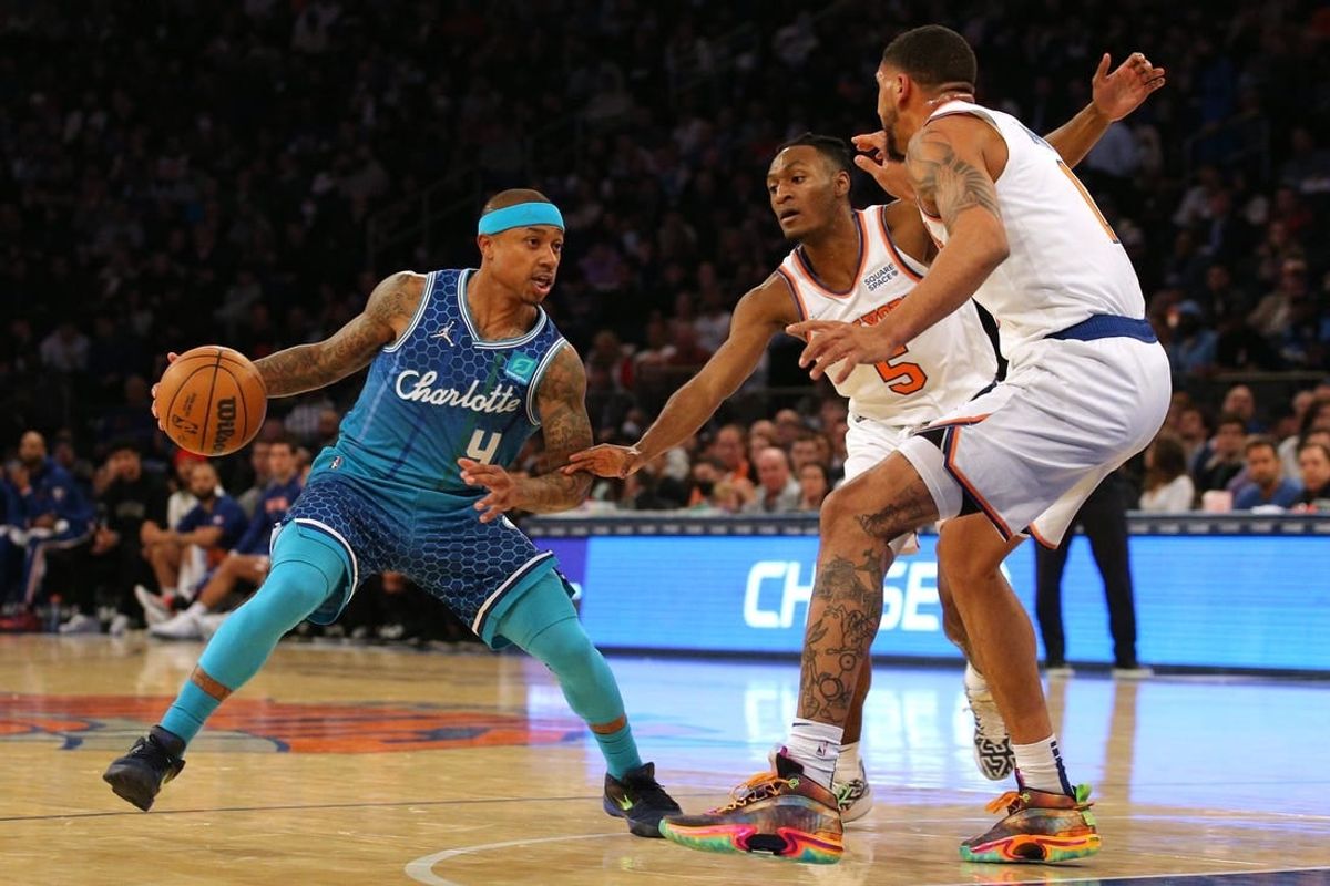 Mar 30, 2022; New York, New York, USA; Charlotte Hornets guard Isaiah Thomas (4) controls the ball against New York Knicks guard Immanuel Quickley (5) and forward Obi Toppin (1) during the second quarter at Madison Square Garden.