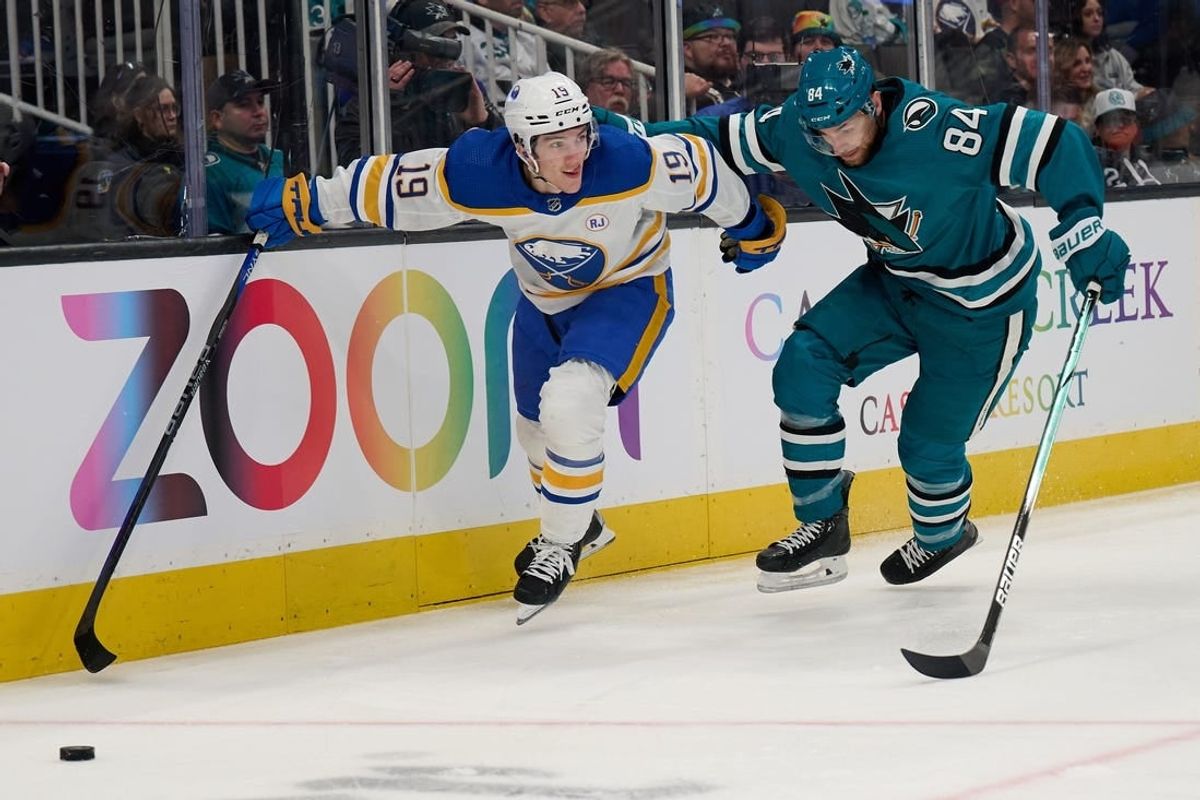Jan 27, 2024; San Jose, California, USA; Buffalo Sabres center Peyton Krebs (19) battles for the puck against San Jose Sharks defenseman Jan Rutta (84) during the first period at SAP Center at San Jose.