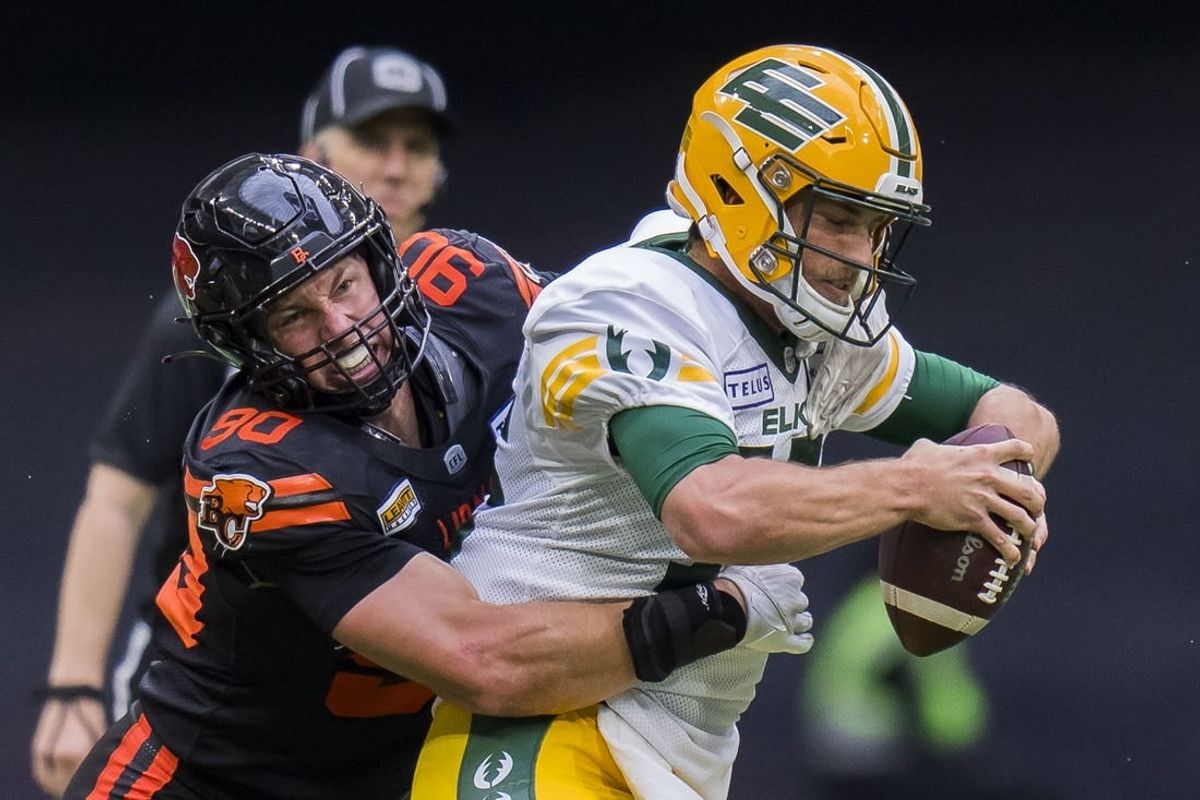 Jun 17, 2023; Vancouver, British Columbia, CAN; BC Lions defensive lineman Mathieu Betts (90) sacks Edmonton Elks quarterback Taylor Cornelius (15) in the second half at BC Place. BC won 22-0.