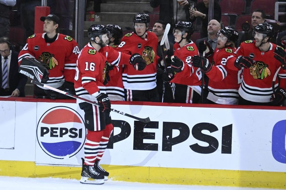 Jan 9, 2024; Chicago, Illinois, USA;  Chicago Blackhawks center Jason Dickinson (16) celebrates with teammates after he scores against the Edmonton Oilers during the first period at the United Center.