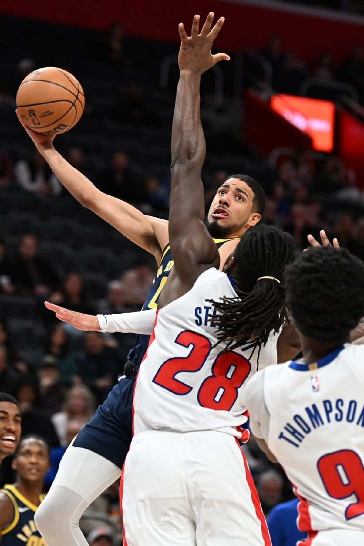 Dec 11, 2023; Detroit, Michigan, USA;  Indiana Pacers guard Tyrese Haliburton (0) shoots over Detroit Pistons center Isaiah Stewart (28) in the first quarter at Little Caesars Arena.