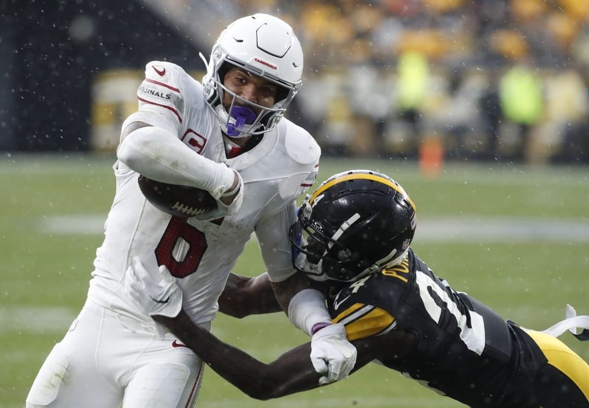 Dec 3, 2023; Pittsburgh, Pennsylvania, USA;  Arizona Cardinals running back James Conner (6) carries the ball against Pittsburgh Steelers cornerback Joey Porter Jr. (24) during the third quarter at Acrisure Stadium.