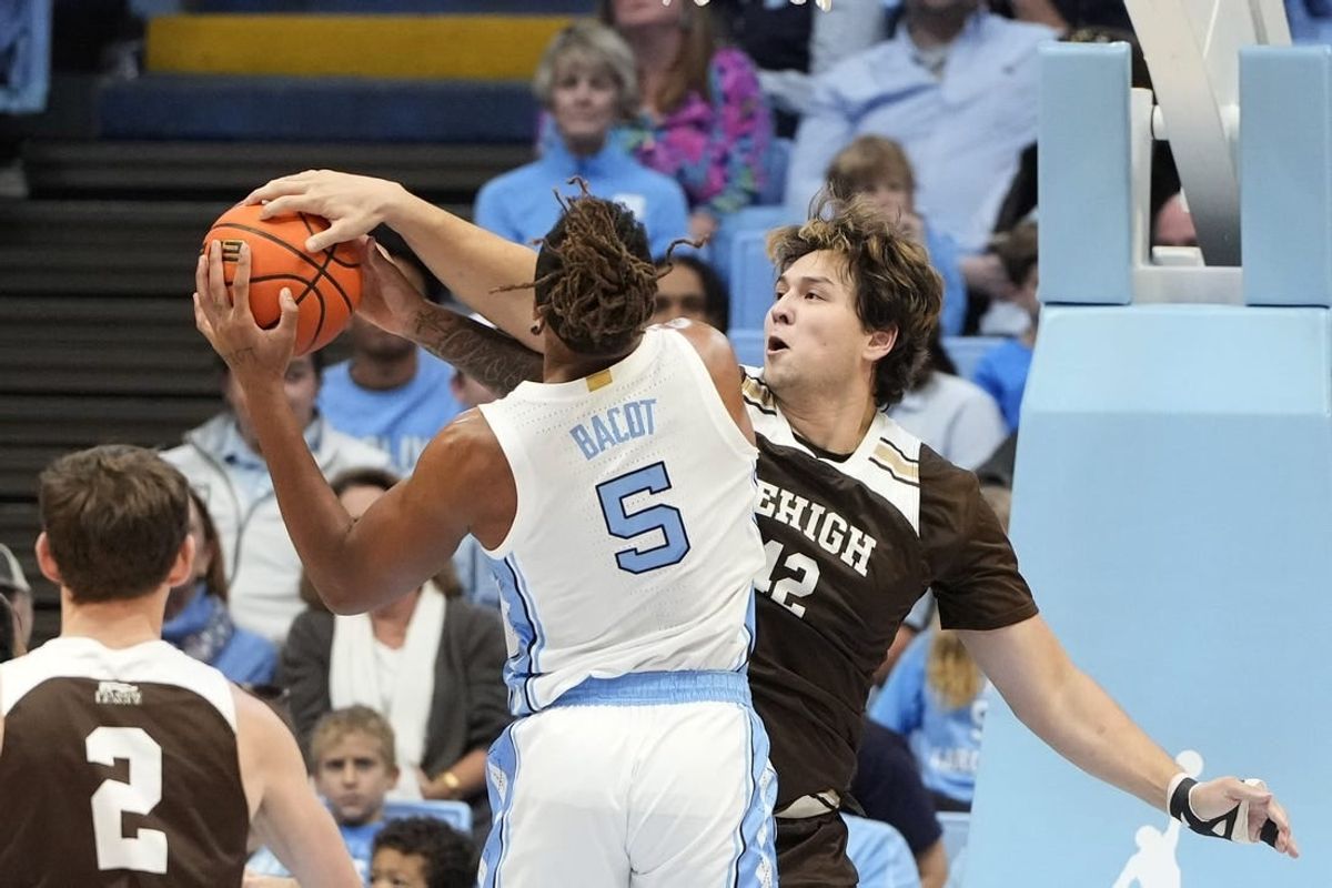 Nov 12, 2023; Chapel Hill, North Carolina, USA; Lehigh Mountain Hawks center JT Tan (42) blocks the shots of North Carolina Tar Heels forward Armando Bacot (5) in the first half at Dean E. Smith Center.