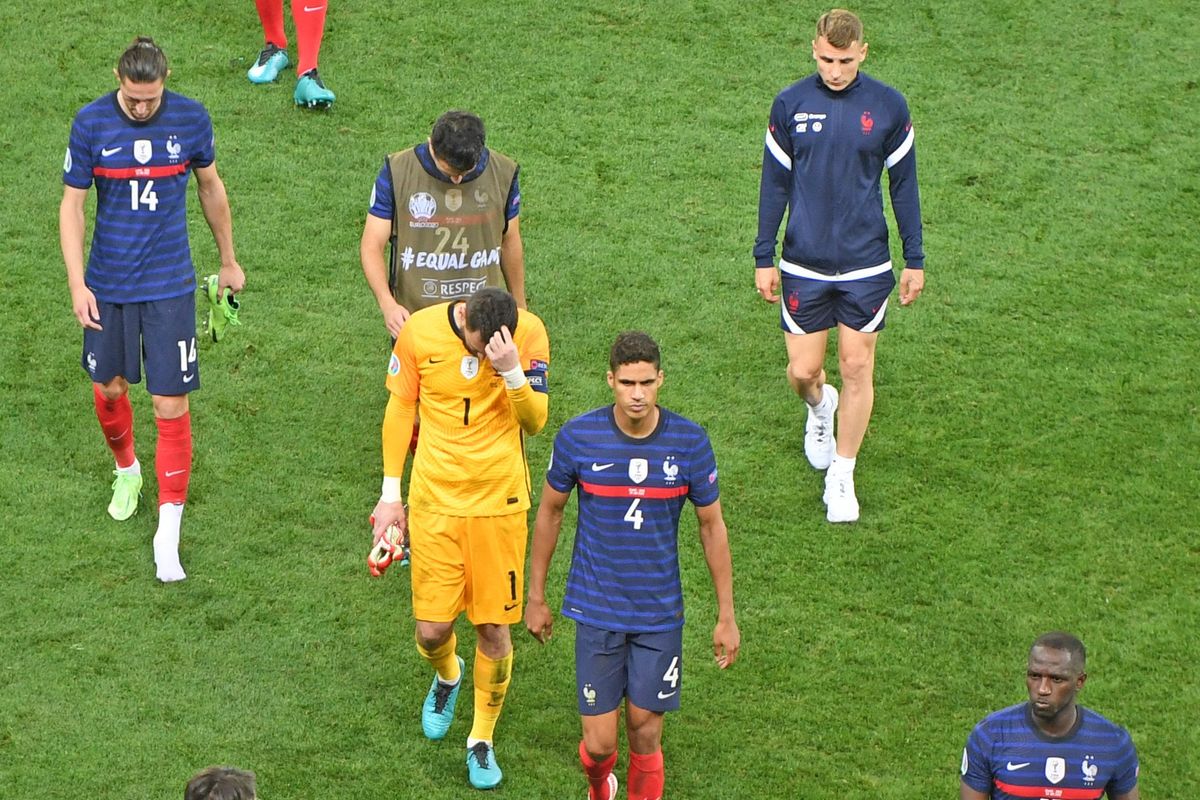 France walks off the pitch, heads down.