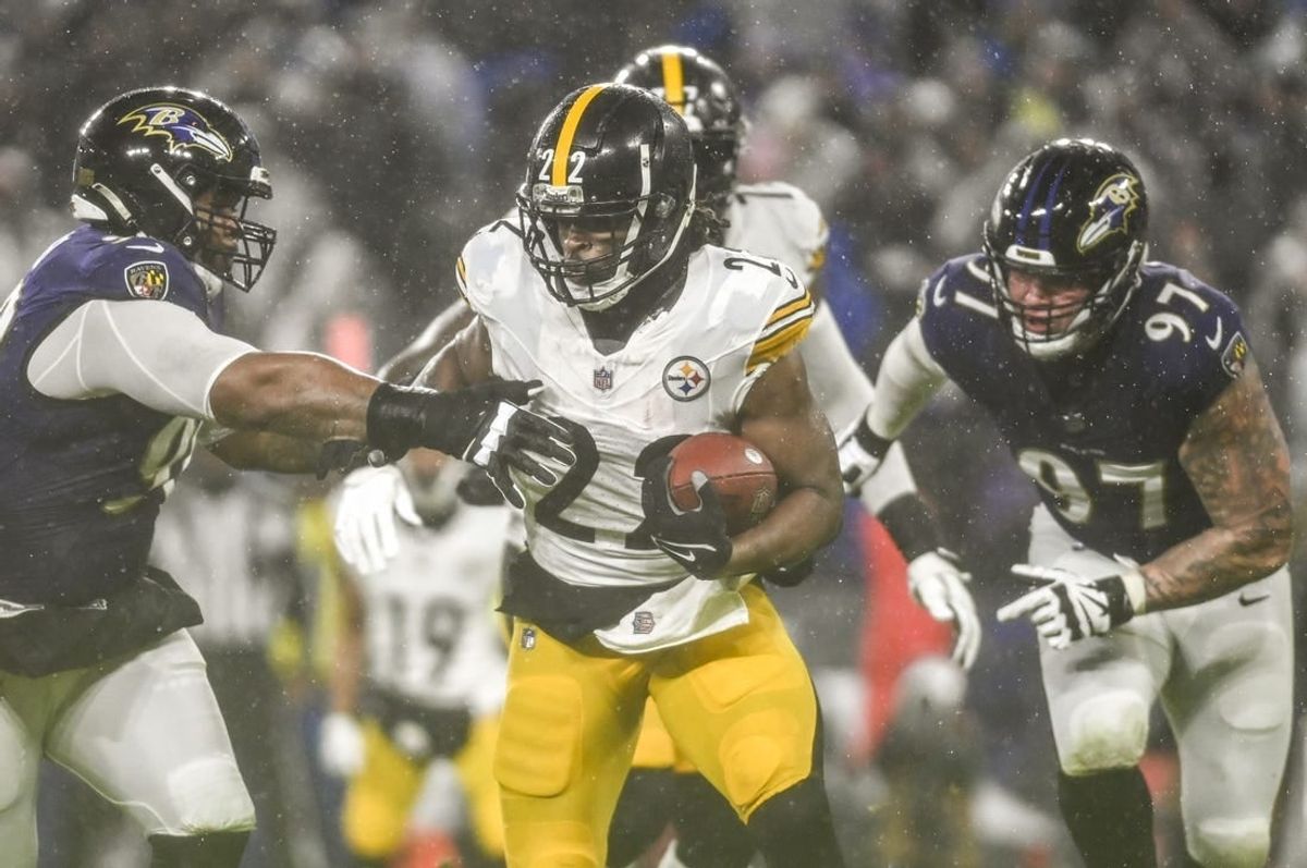 Jan 6, 2024; Baltimore, Maryland, USA;  Pittsburgh Steelers running back Najee Harris (22) rushes as Baltimore Ravens defensive tackle Justin Madubuike (92) defends during the first half at M&T Bank Stadium.