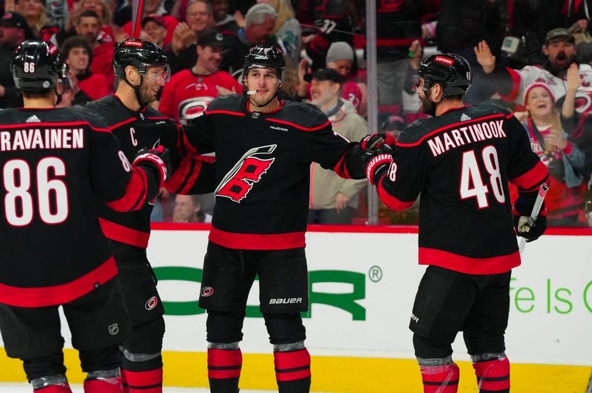 Mar 24, 2024; Raleigh, North Carolina, USA;  Carolina Hurricanes defenseman Brady Skjei (76) celebrates his goal with left wing Jordan Martinook (48) and center Jordan Staal (11) against the Toronto Maple Leafs during the first period at PNC Arena.