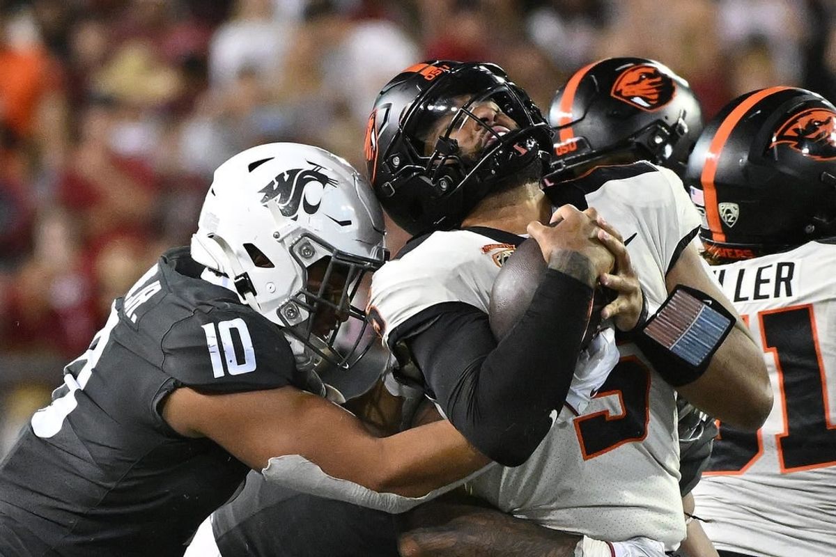Sep 23, 2023; Pullman, Washington, USA; Oregon State Beavers quarterback DJ Uiagalelei (5) is stopped by Washington State Cougars defensive end Ron Stone Jr. (10) in the second half at Gesa Field at Martin Stadium.