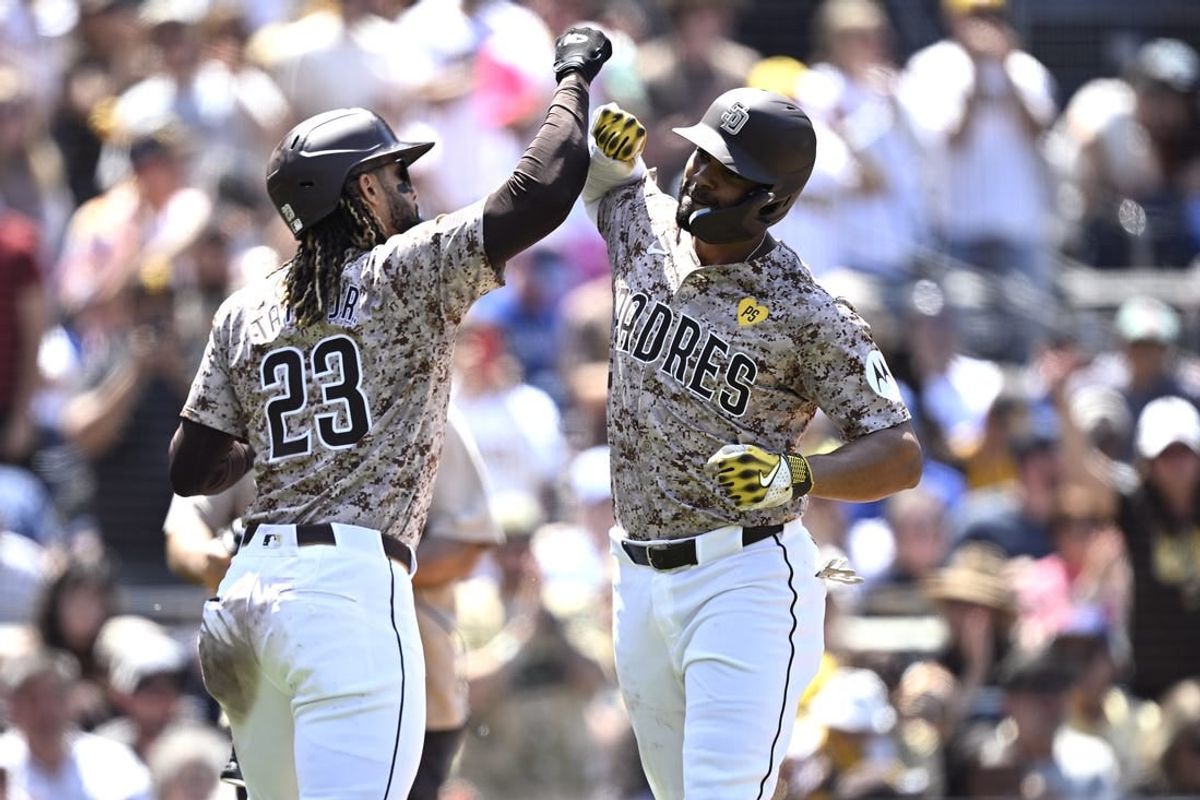 Apr 21, 2024; San Diego, California, USA; San Diego Padres second baseman Xander Bogaerts (right) is congratulated by right fielder Fernando Tatis Jr. (23) after hitting a home run against the Toronto Blue Jays during the third inning at Petco Park.