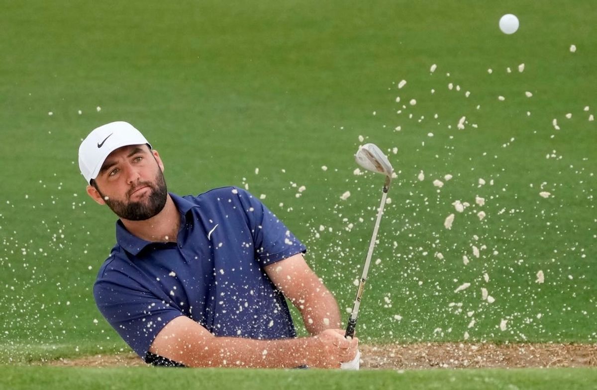 Apr 9, 2024; Augusta, Georgia, USA; Scottie Scheffler hits out of a bunker on no. 2 during a practice round for the Masters Tournament golf tournament at Augusta National Golf Club.