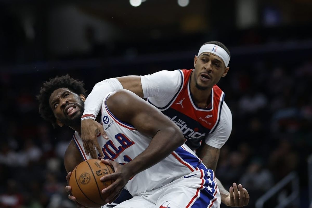 Dec 6, 2023; Washington, District of Columbia, USA; Philadelphia 76ers center Joel Embiid (21) is fouled by Washington Wizards center Daniel Gafford (21) in the second quarter at Capital One Arena.