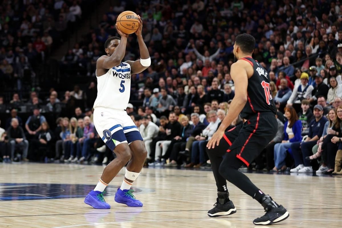 Apr 3, 2024; Minneapolis, Minnesota, USA; Minnesota Timberwolves guard Anthony Edwards (5) shoots as Toronto Raptors forward Garrett Temple (17) defends during the first quarter at Target Center.