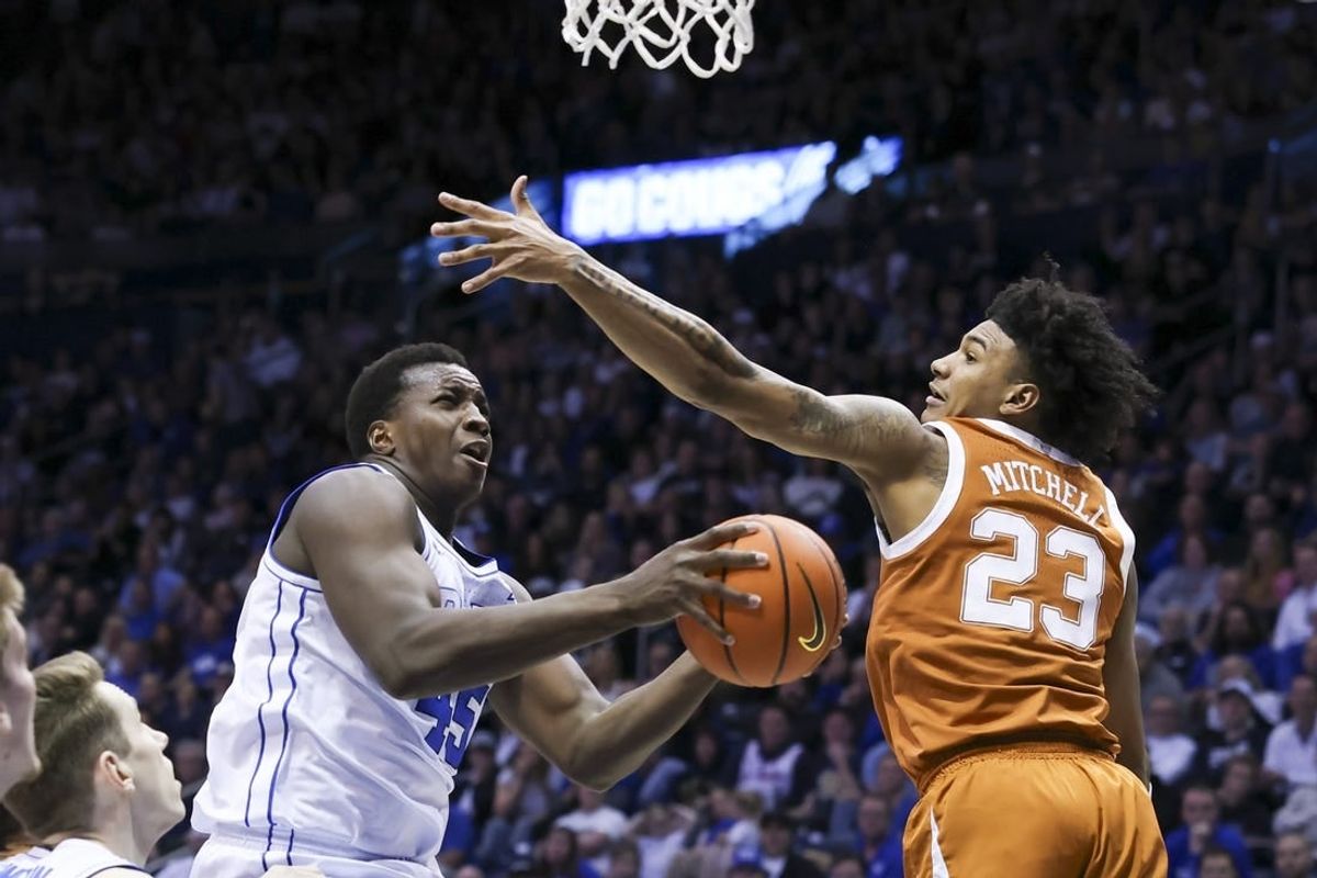 Jan 27, 2024; Provo, Utah, USA; Brigham Young Cougars forward Fousseyni Traore (45) drives to the basket against Texas Longhorns forward Dillon Mitchell (23) during the second half at Marriott Center.