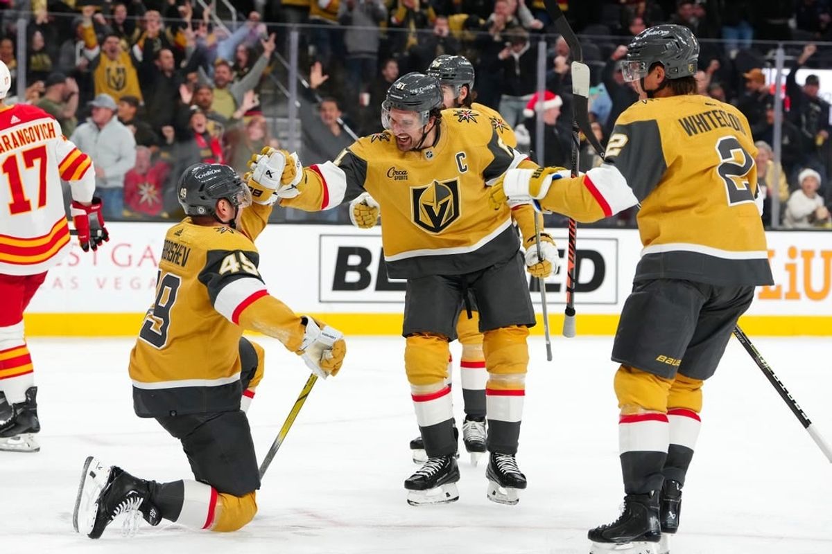 Dec 12, 2023; Las Vegas, Nevada, USA; Vegas Golden Knights center Ivan Barbashev (49) celebrates with Vegas Golden Knights right wing Mark Stone (61) and Vegas Golden Knights defenseman Zach Whitecloud (2) after scoring a goal against the Calgary Flames during the second period at T-Mobile Arena.