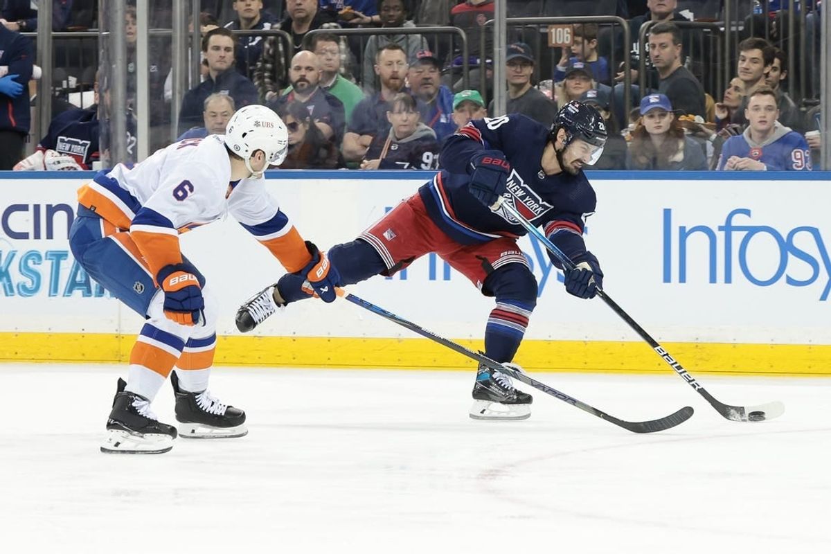 Mar 17, 2024; New York, New York, USA; New York Rangers left wing Chris Kreider (20) shoots the puck as New York Islanders defenseman Ryan Pulock (6) defends during the second period at Madison Square Garden.