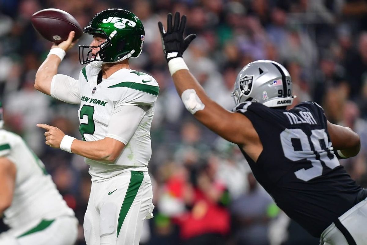 Nov 12, 2023; Paradise, Nevada, USA; New York Jets quarterback Zach Wilson (2) throws under pressure from Las Vegas Raiders defensive tackle Jerry Tillery (90) during the second half at Allegiant Stadium.