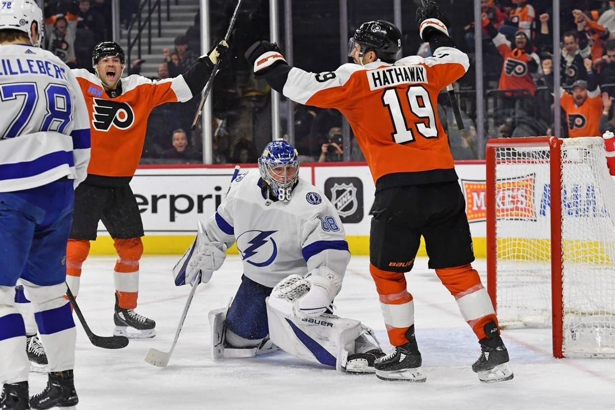 Feb 27, 2024; Philadelphia, Pennsylvania, USA; Philadelphia Flyers center Ryan Poehling (25) and right wing Garnet Hathaway (19) celebrate goal by defenseman Travis Sanheim (6) (not pictured) against Tampa Bay Lightning goaltender Andrei Vasilevskiy (88) during the third period at Wells Fargo Center.