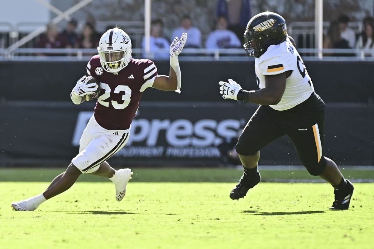 Nov 18, 2023; Starkville, Mississippi, USA; Mississippi State Bulldogs running back Seth Davis (23) runs the ball while defended by Southern Miss Golden Eagles defensive tackle Josh Ratcliff (93) during the second quarter at Davis Wade Stadium at Scott Field.