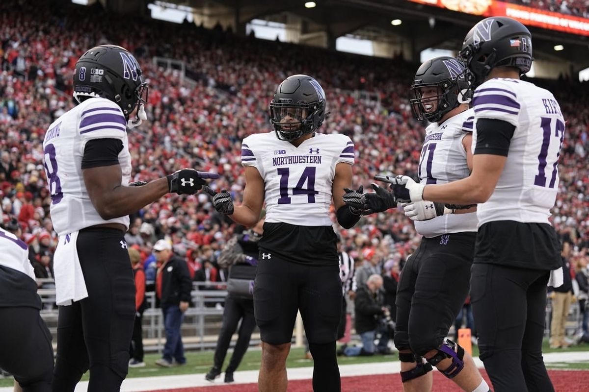 Nov 11, 2023; Madison, Wisconsin, USA;  Northwestern Wildcats wide receiver Cam Johnson (14) celebrates after scoring a touchdown during the second quarter against the Wisconsin Badgers at Camp Randall Stadium.