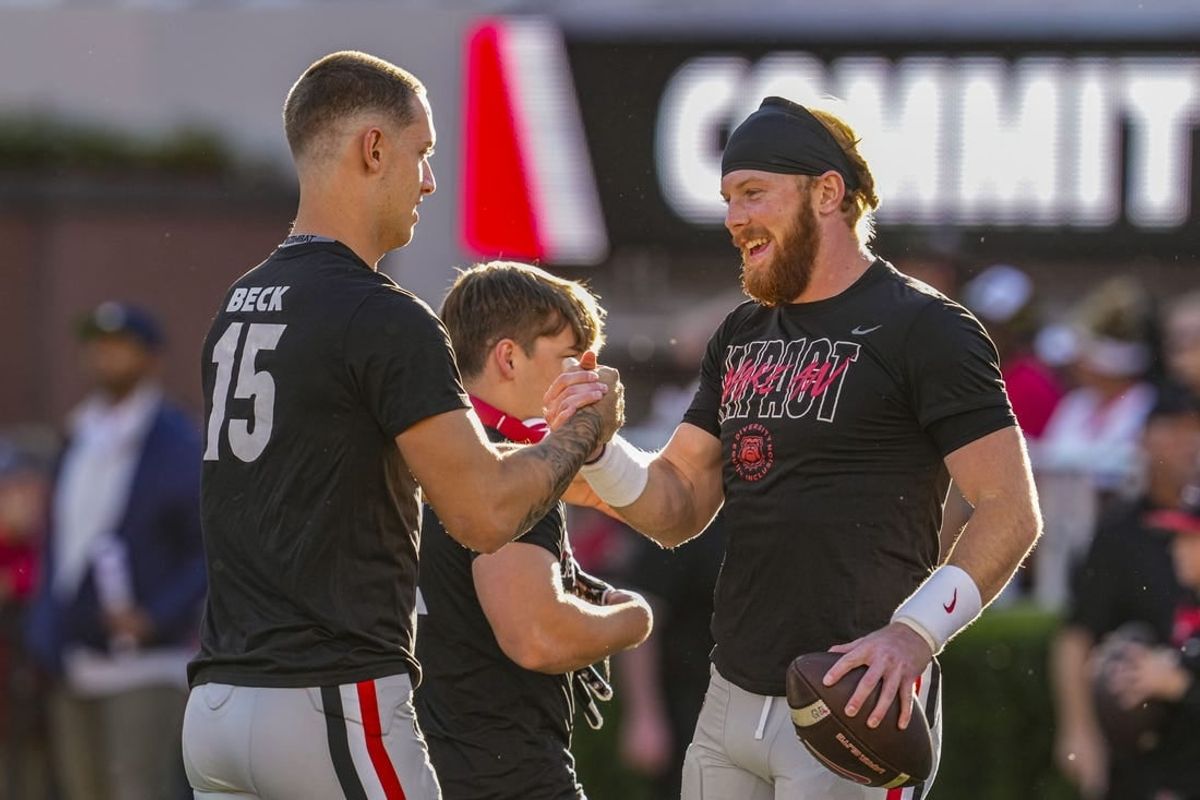 Georgia Bulldogs quarterbacks Carson Beck (15) and quarterback Brock Vandagriff (12) react on the field prior to the game against the Kentucky Wildcats at Sanford Stadium.