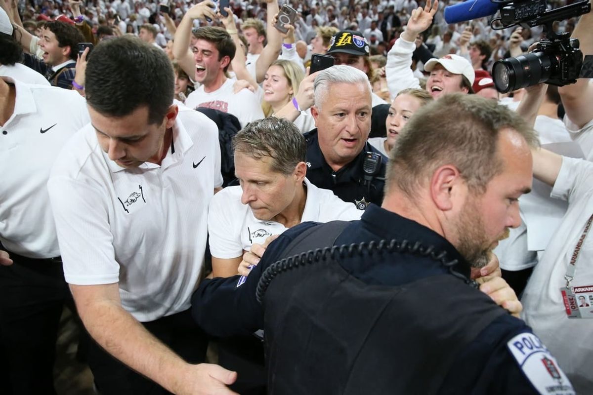 Nov 29, 2023; Fayetteville, Arkansas, USA; Arkansas Razorbacks head coach Eric Musselman is ushered off of the court by police after the game against the Duke Blue Devils at Bud Walton Arena. Arkansas won 80-75.