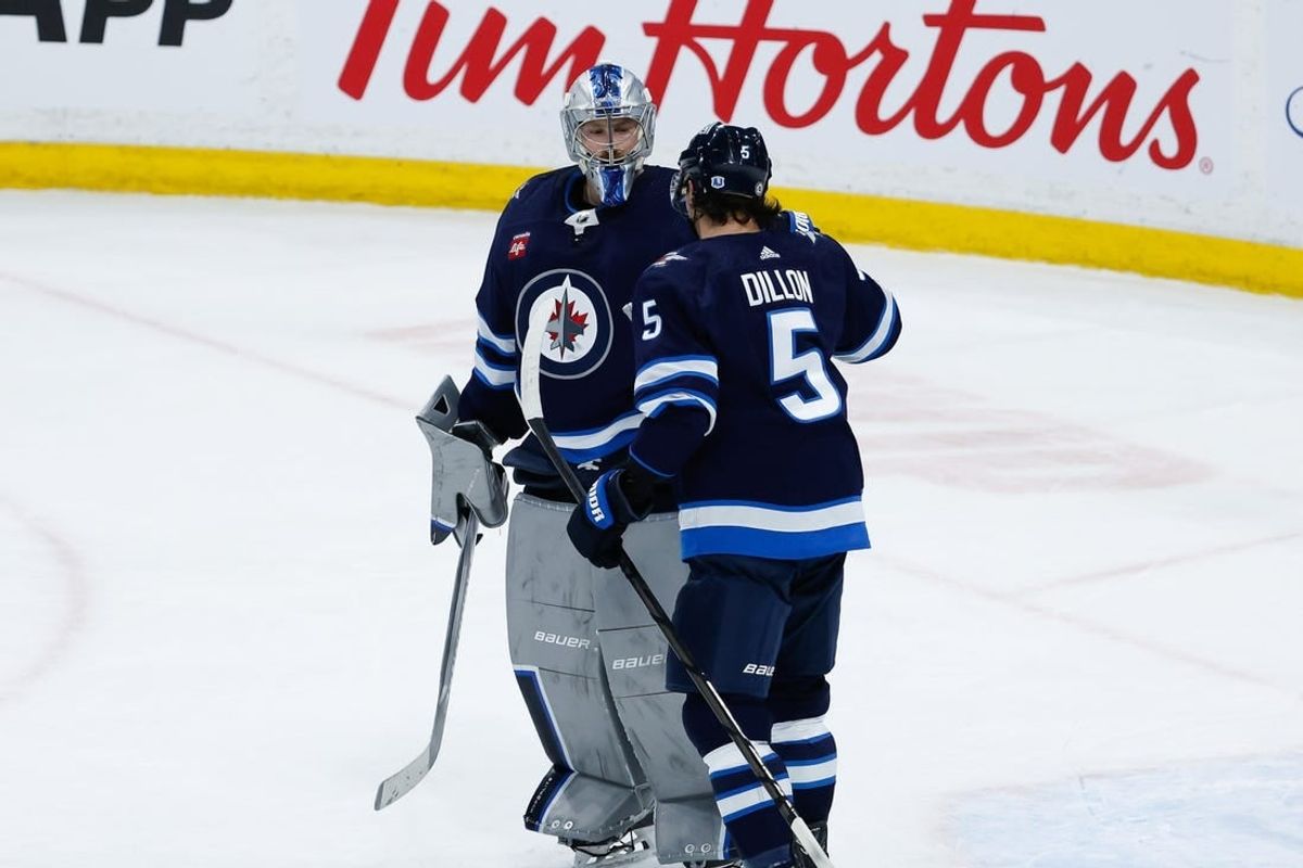 Feb 27, 2024; Winnipeg, Manitoba, CAN; Winnipeg Jets goalie Laurent Boissoit (39) is congratulated by Winnipeg Jets defenseman Brenden Dillon (5) on his win against the St. Louis Blues at the end of the third period at Canada Life Centre.