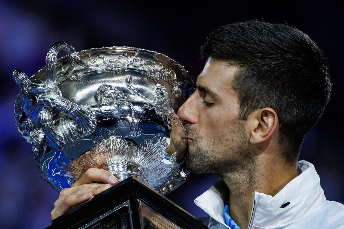 Jan 29, 2023; Melbourne, Victoria, Australia; Novak Djokovic of Serbia celebrates with the trophy after his victory over Stefanos Tsitsipas of Greece in the men's final on day fourteen of the 2023 Australian Open tennis tournament at Melbourne Park.