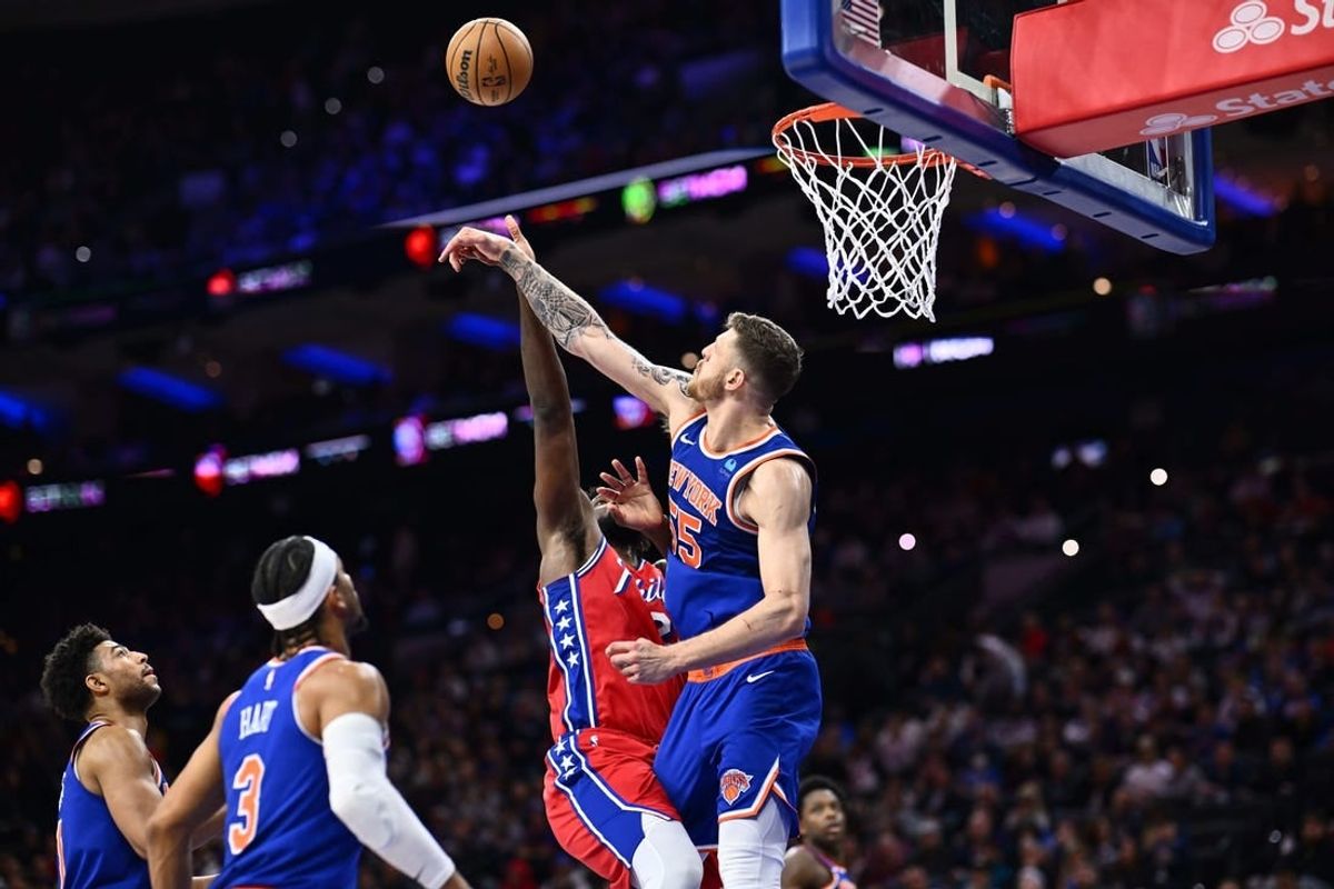 Jan 5, 2024; Philadelphia, Pennsylvania, USA; New York Knicks center Isaiah Hartenstein (55) blocks a shot from Philadelphia 76ers center Joel Embiid (21) in the fourth quarter at Wells Fargo Center.