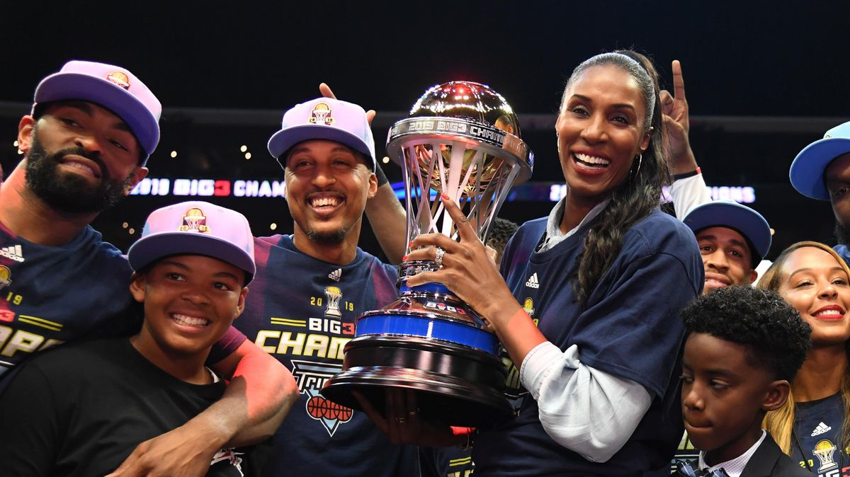 Lisa Leslie, Jamario Moon and the Triplets celebrate with the trophy after defeating the Killer 3s to win the BIG3 Championship in 2019.