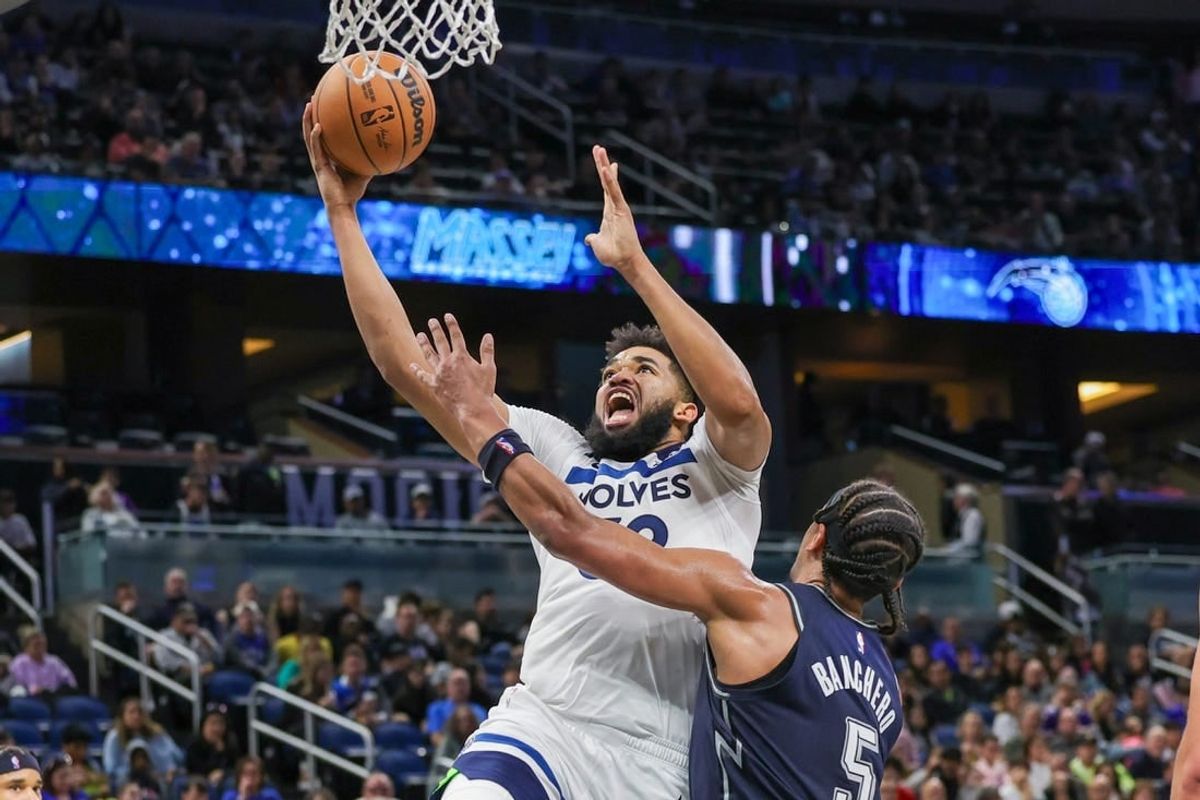 Jan 9, 2024; Orlando, Florida, USA; Minnesota Timberwolves center Karl-Anthony Towns (32) goes to the basket against Orlando Magic forward Paolo Banchero (5) during the second quarter at KIA Center.