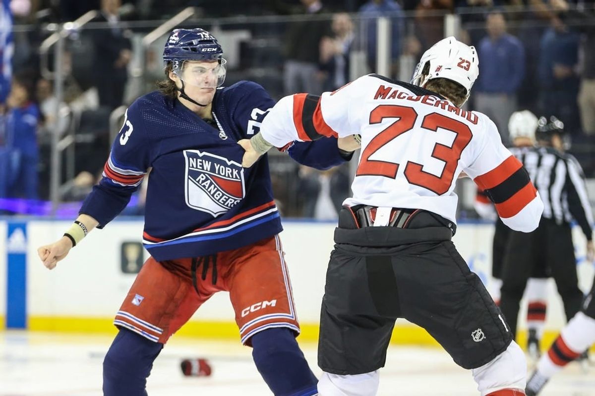 Apr 3, 2024; New York, New York, USA; New York Rangers center Matt Rempe (73) and New Jersey Devils defenseman Kurtis MacDermid (23) fight at start of the 1st period at Madison Square Garden.