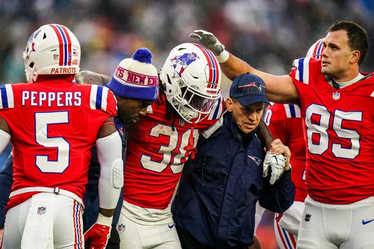 Dec 3, 2023; Foxborough, Massachusetts, USA; New England Patriots running back Rhamondre Stevenson (38) is helped off the field as they take on the Los Angeles Chargers in the second quarter at Gillette Stadium.