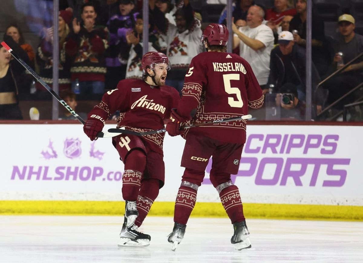 Nov 30, 2023; Tempe, Arizona, USA; Arizona Coyotes left wing Michael Carcone (53) celebrates with defenseman Michael Kesselring (5) after scoring a goal against the Colorado Avalanche in the third period at Mullett Arena.