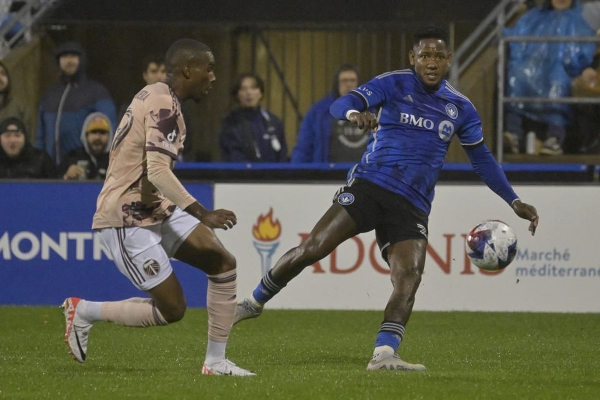 Oct 7, 2023; Montreal, Quebec, CAN; CF Montreal forward Romell Quioto (30) passes the ball against Portland Timbers defender Juan Mosquera (29) in the first half at Stade Saputo.