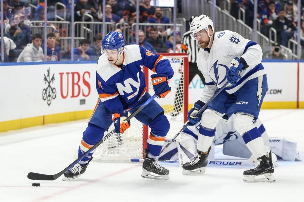 Feb 24, 2024; Elmont, New York, USA;  New York Islanders center Jean-Gabriel Pageau (44) and Tampa Bay Lightning defenseman Erik Cernak (81) battle for control of the puck in the second period at UBS Arena.