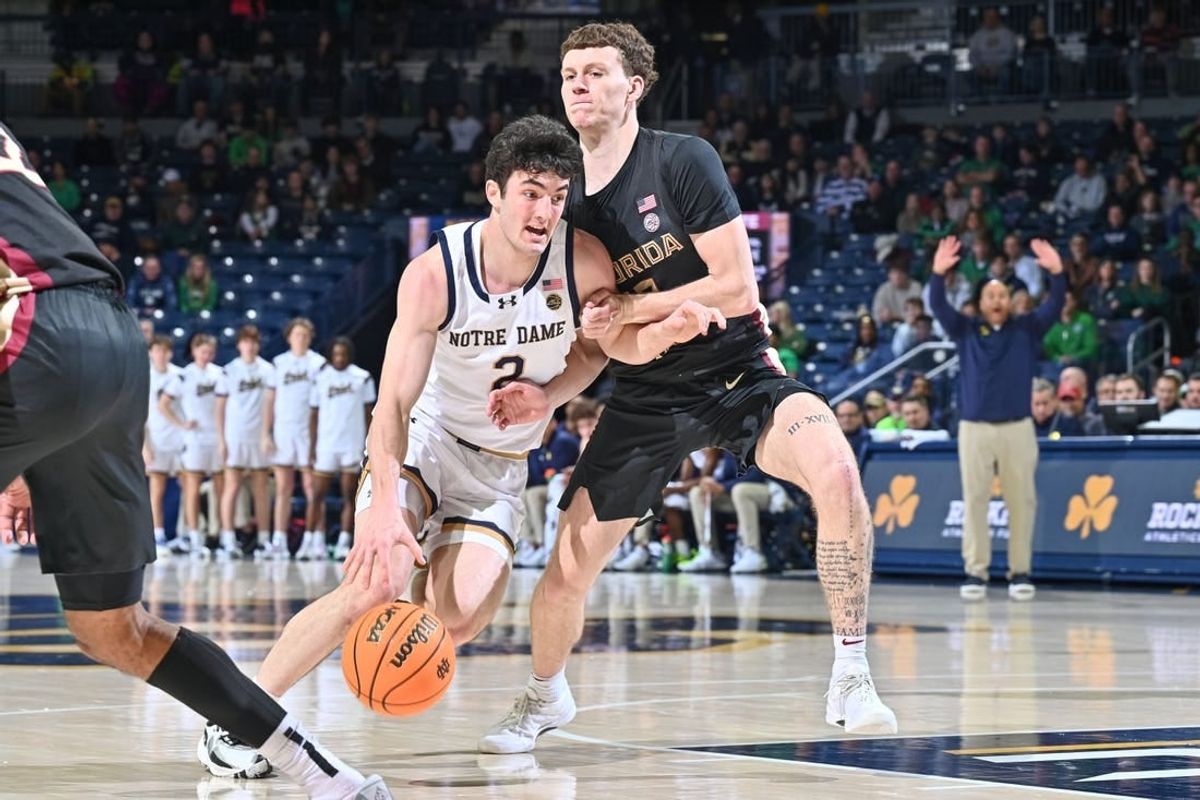 Jan 13, 2024; South Bend, Indiana, USA; Notre Dame Fighting Irish guard Logan Imes (2) drives to the basket as Florida State Seminoles guard Tom House (12) defends in the first half at the Purcell Pavilion.