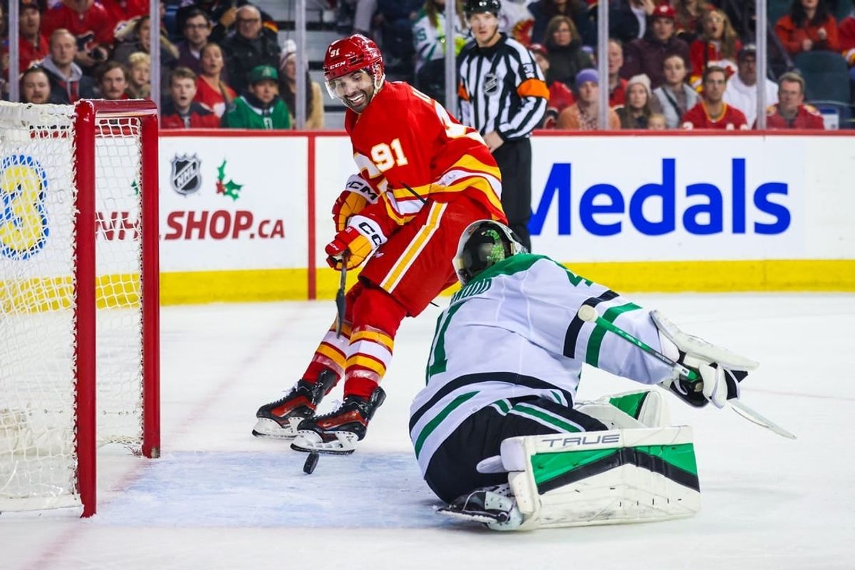 Nov 30, 2023; Calgary, Alberta, CAN; Calgary Flames center Nazem Kadri (91) scores a goal against Dallas Stars goaltender Scott Wedgewood (41) during the overtime period at Scotiabank Saddledome.