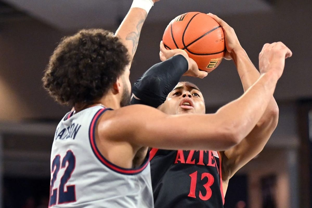 Dec 29, 2023; Spokane, Washington, USA; San Diego State Aztecs forward Jaedon LeDee (13) shoots the ball against Gonzaga Bulldogs forward Anton Watson (22) in the first half at McCarthey Athletic Center.