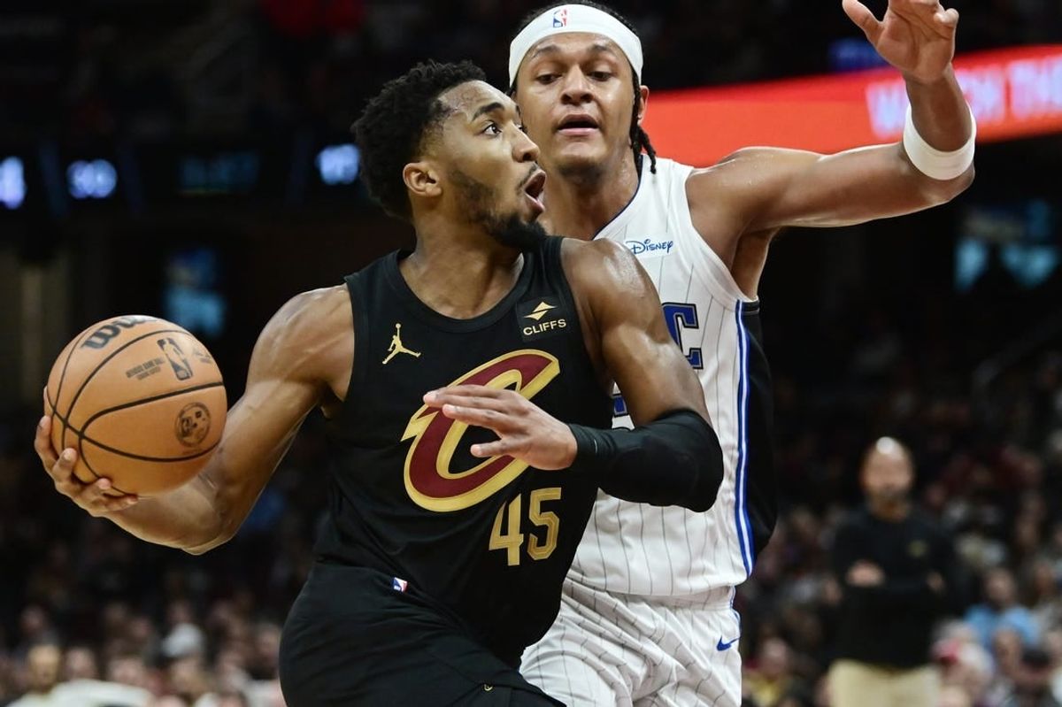 Dec 6, 2023; Cleveland, Ohio, USA; Cleveland Cavaliers guard Donovan Mitchell (45) drives to the basket against Orlando Magic forward Paolo Banchero (5) during the second half at Rocket Mortgage FieldHouse.