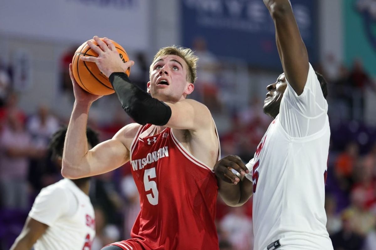 Nov 22, 2023; Fort Myers, FL, USA;  Wisconsin Badgers forward Tyler Wahl (5) drives tot the basket past Southern Methodist Mustangs forward Ja'Heim Hudson (15) in the second half during the Fort Myers Tip-Off championship game at Suncoast Credit Union Arena.