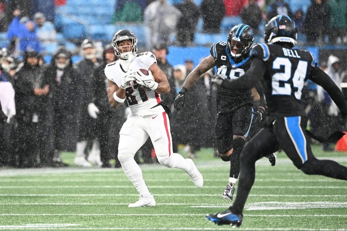 Dec 17, 2023; Charlotte, North Carolina, USA; Atlanta Falcons tight end Jonnu Smith (81) catches the ball as Carolina Panthers linebacker Frankie Luvu (49) and safety Vonn Bell (24) defend in the second quarter at Bank of America Stadium.