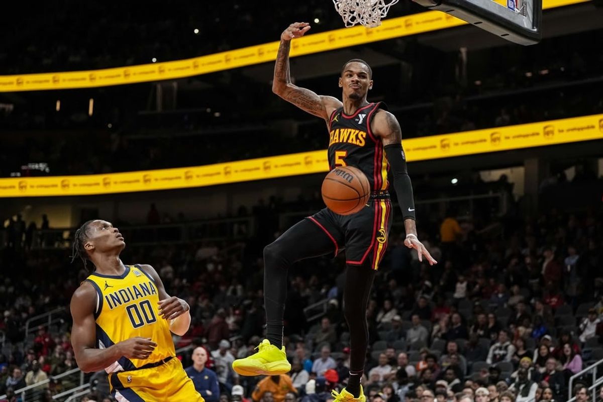 Jan 12, 2024; Atlanta, Georgia, USA; Atlanta Hawks guard Dejounte Murray (5) dunks the ball against the Indiana Pacers during the second half at State Farm Arena.