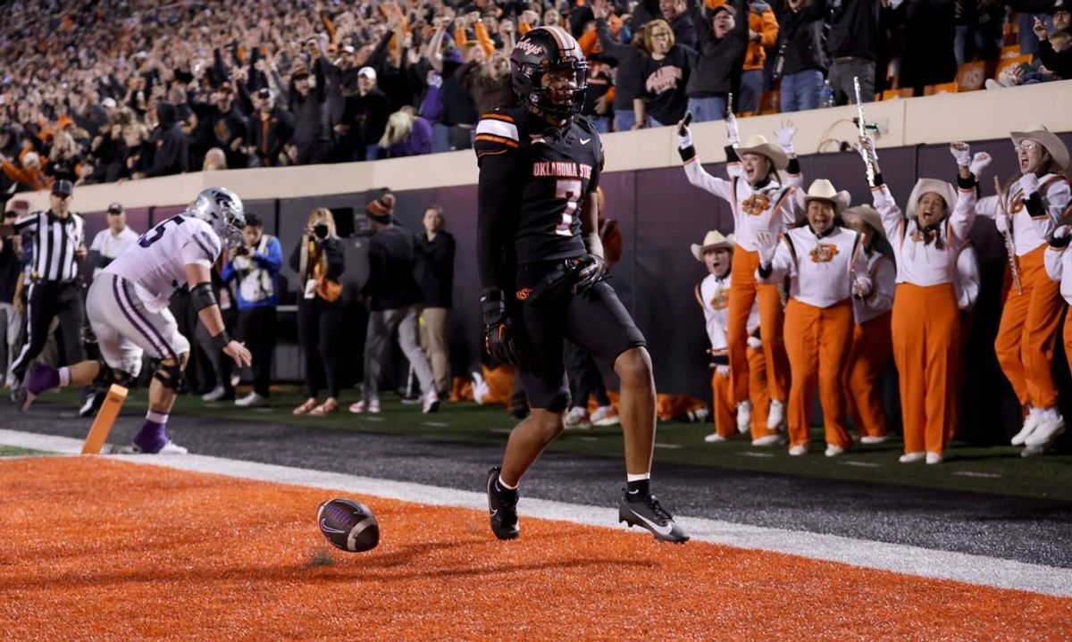 Oklahoma State's Cameron Epps (7) returns an interception for a touchdown in front of Kansas State's Hayden Gillum (55) in the first half of the college football game between the Oklahoma State University Cowboys and the Kansas State Wildcats at Boone Pickens Stadium in Stillwater. Okla., Friday, Oct. 6, 2023.