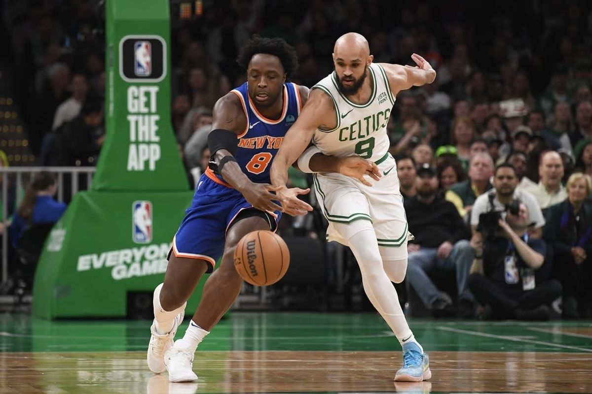 Apr 11, 2024; Boston, Massachusetts, USA;  New York Knicks forward OG Anunoby (8) and Boston Celtics guard Derrick White (9) battle for a loose ball during the first half at TD Garden.