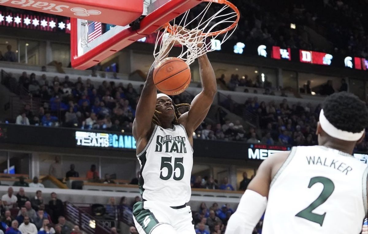 Nov 14, 2023; Chicago, Illinois, USA; Michigan State Spartans forward Coen Carr (55) dunks the ball against the Duke Blue Devils during the second half at United Center.