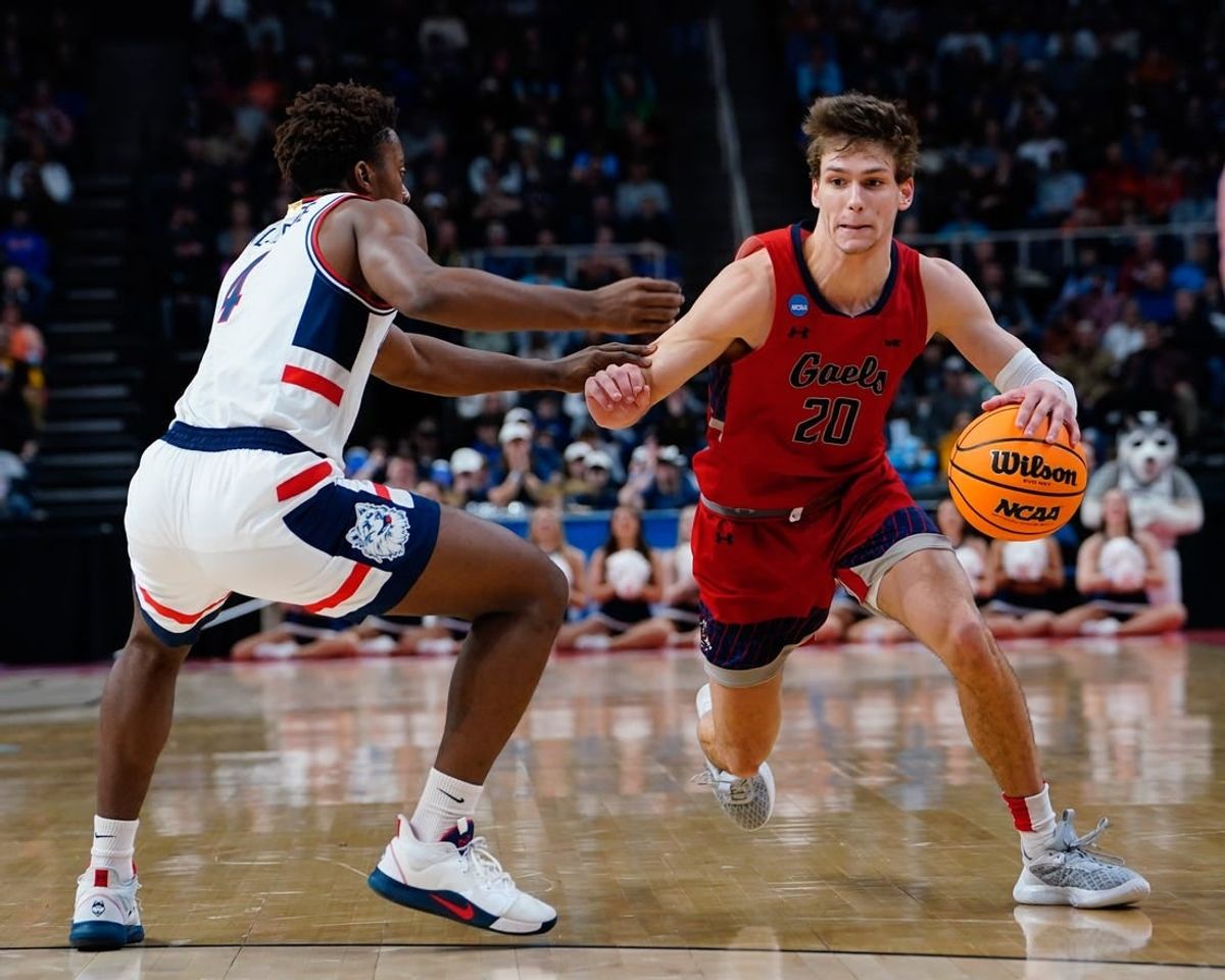 Mar 19, 2023; Albany, NY, USA; Saint Mary's Gaels guard Aidan Mahaney (20) dribbles the ball against Connecticut Huskies guard Nahiem Alleyne (4) during the second half at MVP Arena.